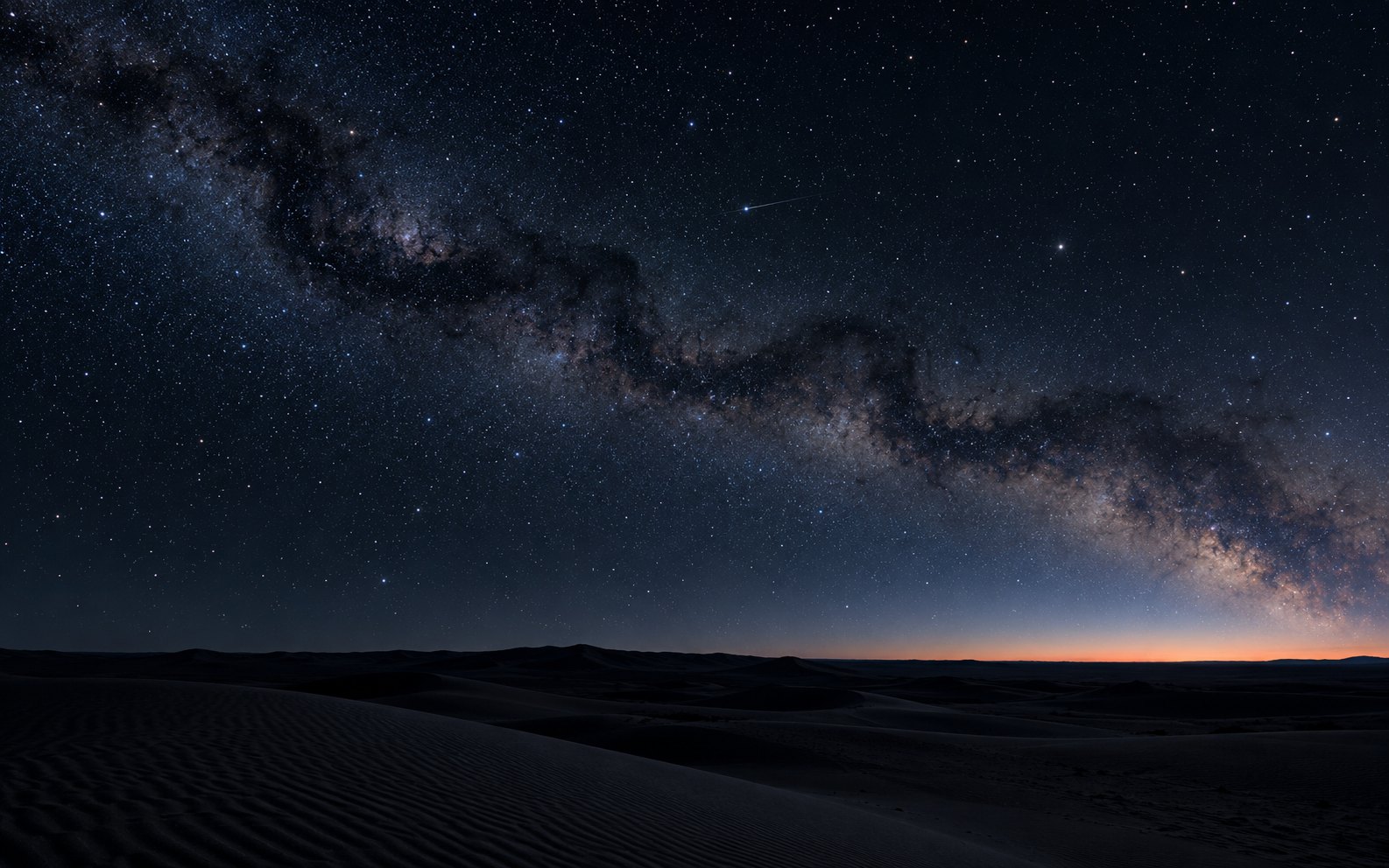 The Milky Way coiling like a serpent over a dark desert, with a single bright moving point crossing the sky and a thin line of sunset on the horizon